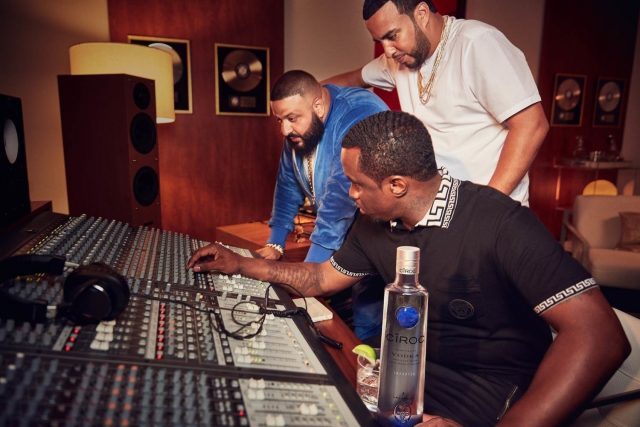 Puffy, DJ Khaled and French Montana pretending to mix on a desk
