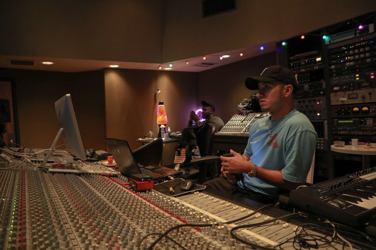 GRyOMO in the studio with a laptop and what appears to be a focusrite interface on a mixing desk.